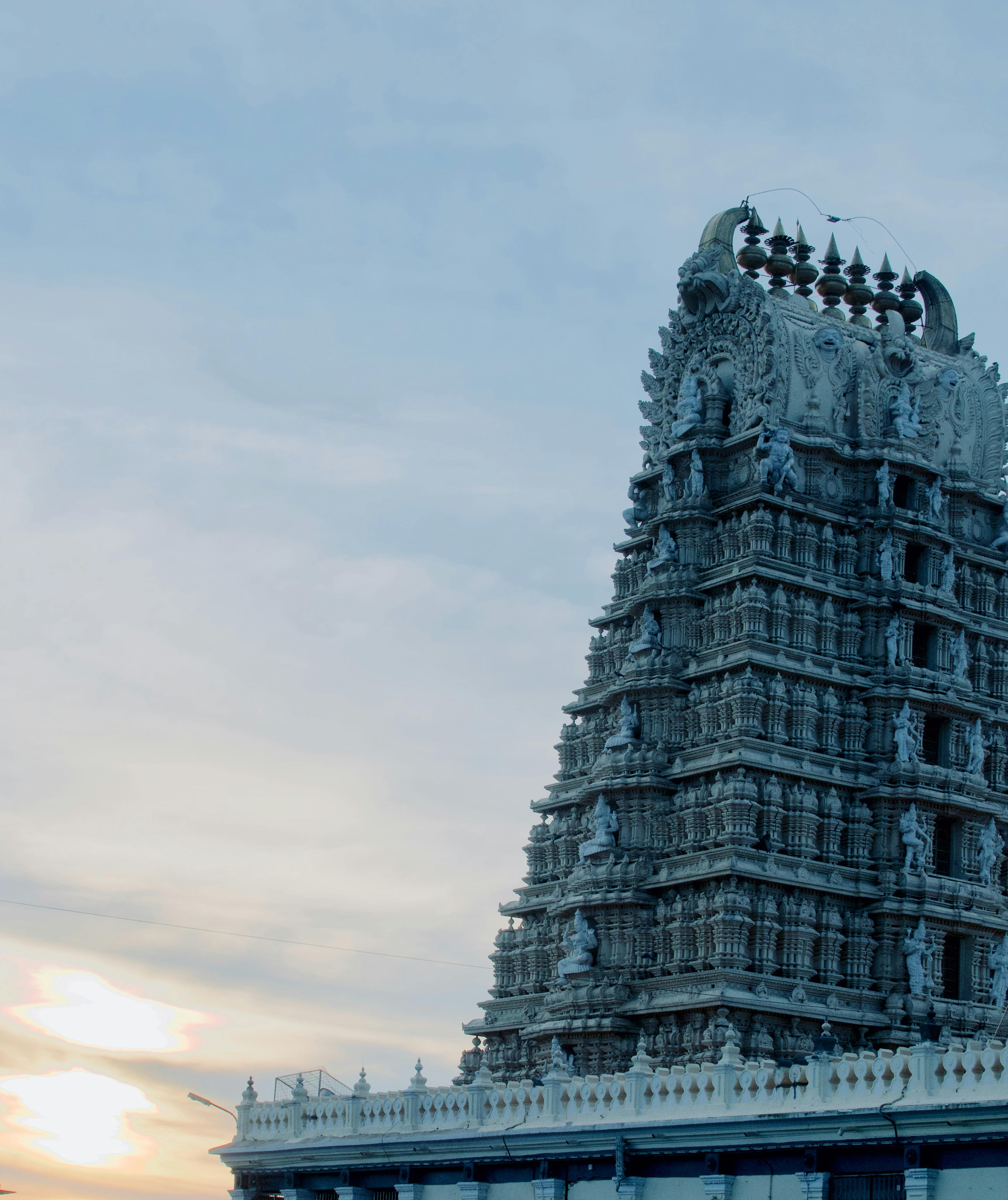 A temple gopuram against the morning sky